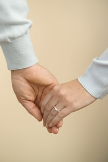 Husband and wife holding hands.