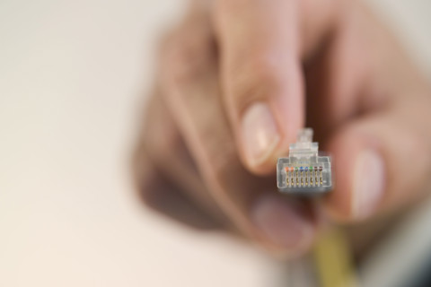 Person connecting a cable.