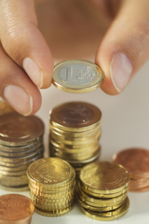 Man stacking Euro coins.