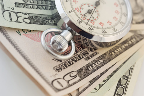Still life of stopwatch and money.