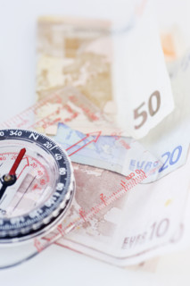 Compass with money - high angle.