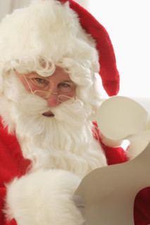 Closeup of Santa checking his list.