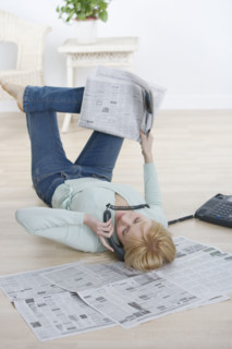 Woman on phone lying on back.