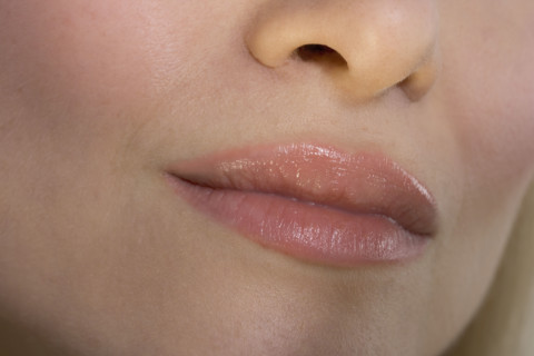 Closeup of woman's lips and nose.