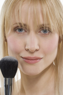 Woman with powder brush.