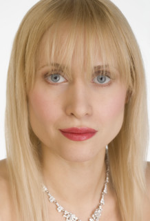 Portrait of woman wearing necklace.