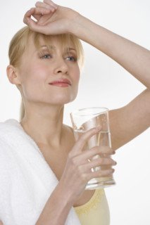 Woman with towel and water glass.