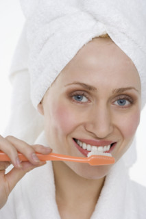 Woman brushing teeth.