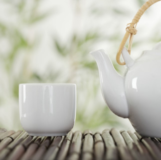 Teapot and cup on bamboo.