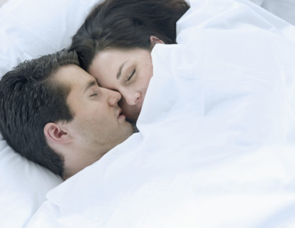 Couple asleep in bed.
