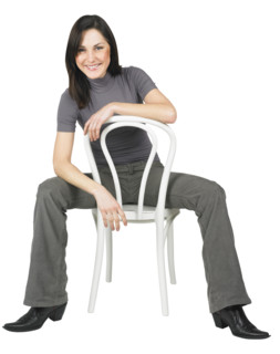 Portrait of a woman sitting on a chair.