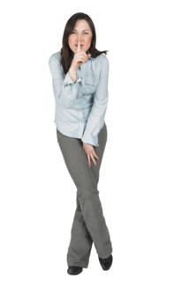 Woman gesturing to be quiet.