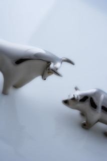 Bull and bear figurines facing-off.