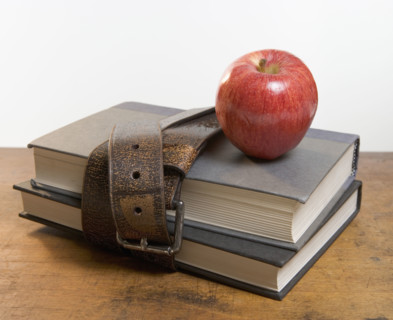 Schoolbooks with red apple.