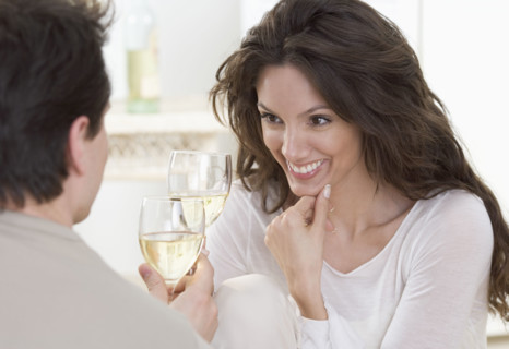Couple toasting with white wine.