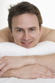 Headshot of smiling man with towel.