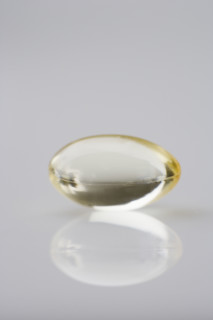 One gelcap and its reflection.