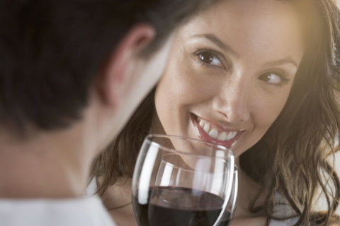 Couple holding wine glasses.