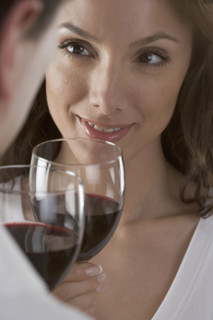 Couple holding wine glasses.