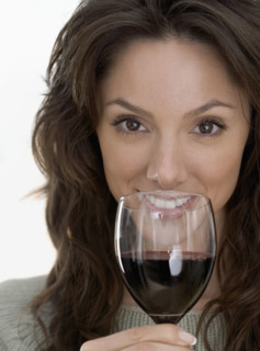 Smiling woman with red wine.