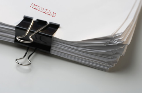 Sheaf of papers marked confidential.
