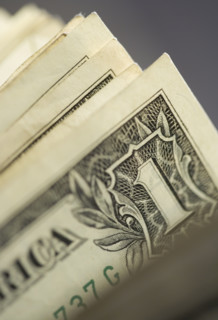 Closeup of corners of dollar bills.