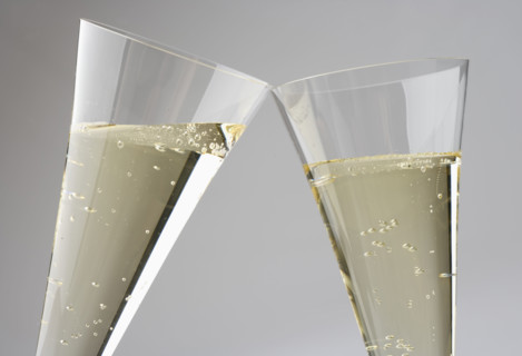 Closeup of toasting with champagne glasses.