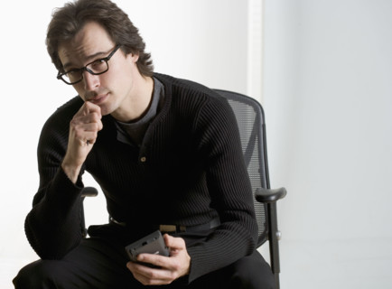 Professional man sitting thoughtfully.