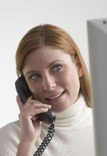 Woman on telephone with computer.