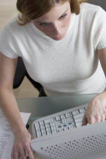 Woman working on computer at desk.