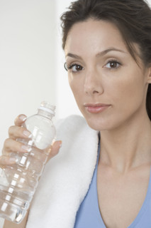 Woman with towel and water bottle.