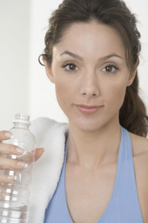 Smiling woman with water bottle.