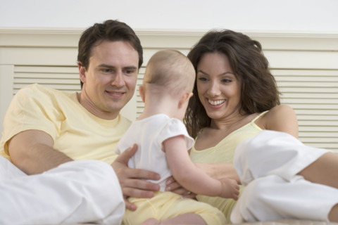 Couple relaxing with infant.