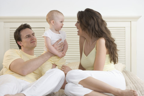 Mom talking to baby with dad.