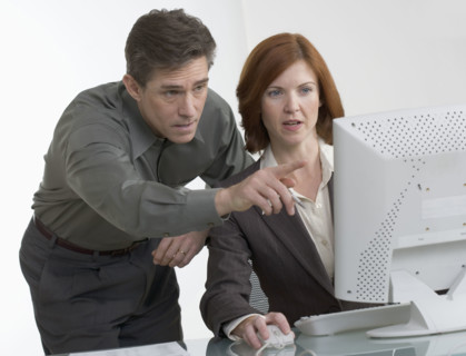 Business people looking at computer screen.