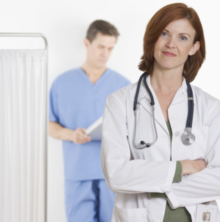 Female doctor smiling confidently.