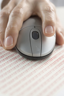 Hand on mouse with binary code.