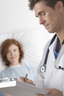 Doctor taking notes with patient.