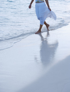 Woman strolling the beach.