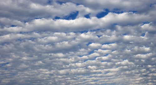 White clouds covering blue sky.