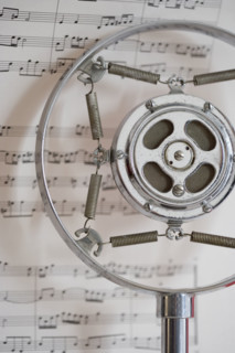 Still life of microphone and sheet music.