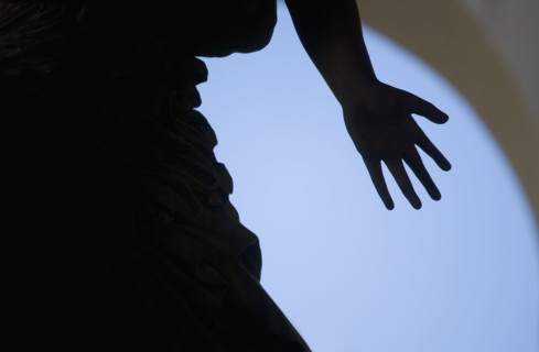 Silhouette of hand on statue Florence Italy.