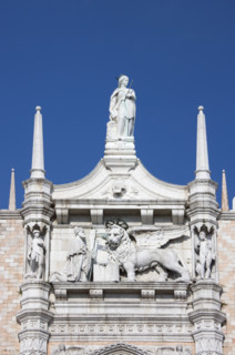 Doges' Palace with Statue of the Doge before the Symbol of Venice Italy.