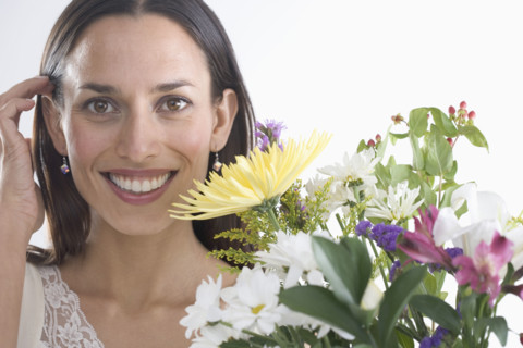 Woman holding bouquet of flowers.