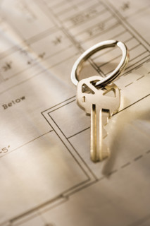 Still life of a key on blueprint .