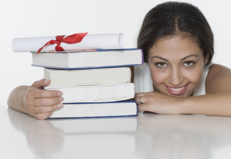 Woman with textbooks and diploma.