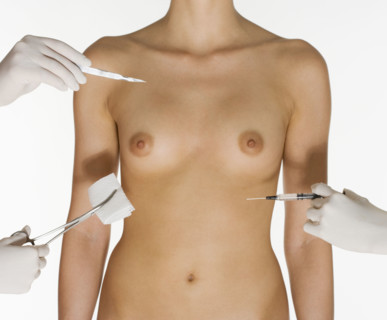 Nude female torso with medical instruments.