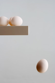 Egg falling off edge of table.