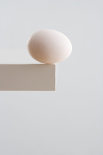 Egg on edge of table.