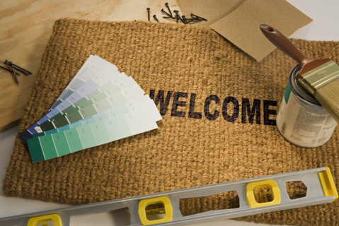 Welcome mat with paint and tools.